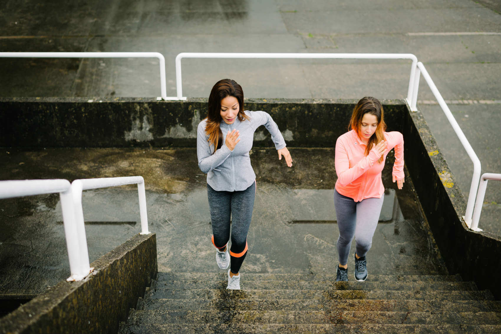 two women doing HIIT stairs workout outdoors