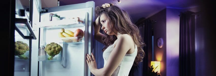 woman holding open with hands staring at the interior contents looking perplexed