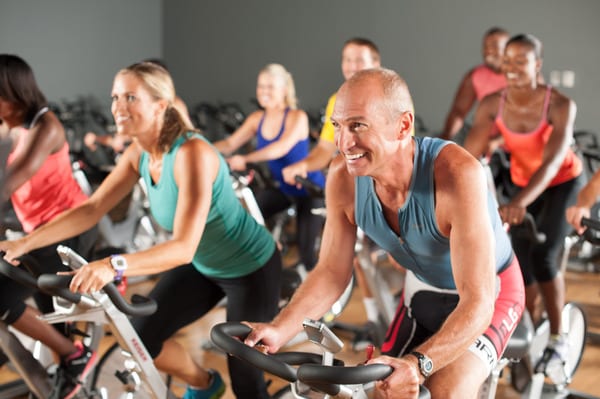 fitness members cycling in brick biking classes in padonia gym