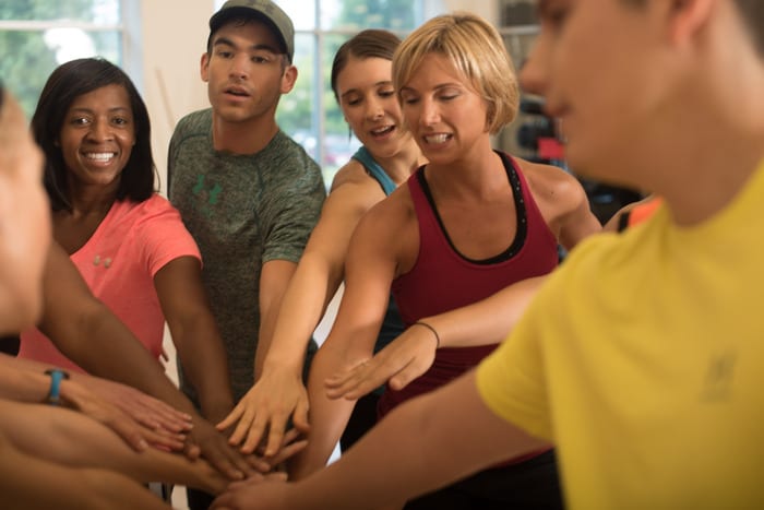 team camaraderie during before group fitness class at brick bodies gym in reisterstown