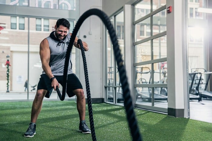 man using ropes at rotunda gym in inferno group training class