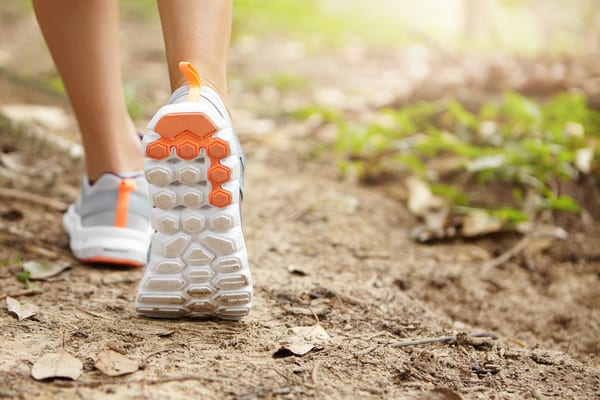 woman on walk in nature with tennis shoes