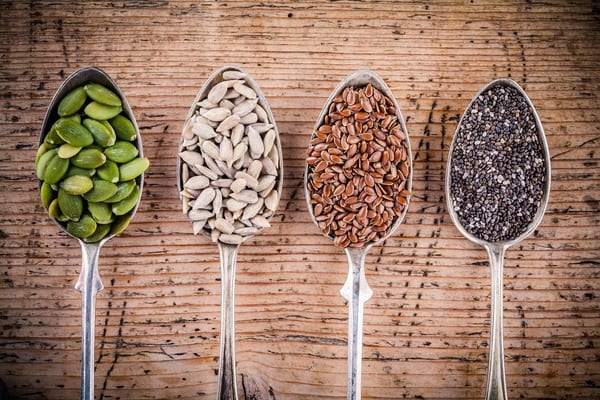 spoons with seeds from brick bodies nutrition tips on what seeds are great to incorporate into diet