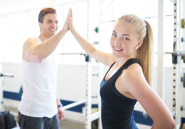 couple high fiving at brick bodies rotunda gym