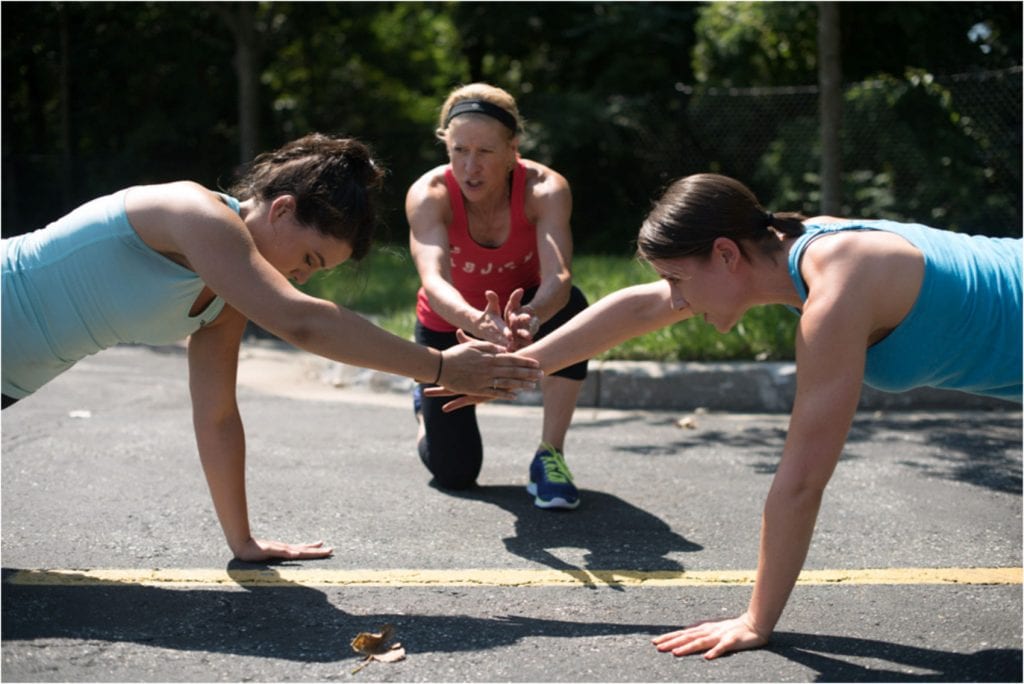 brick bodies padonia md gym club members performing mountain climbing exercises outdoors