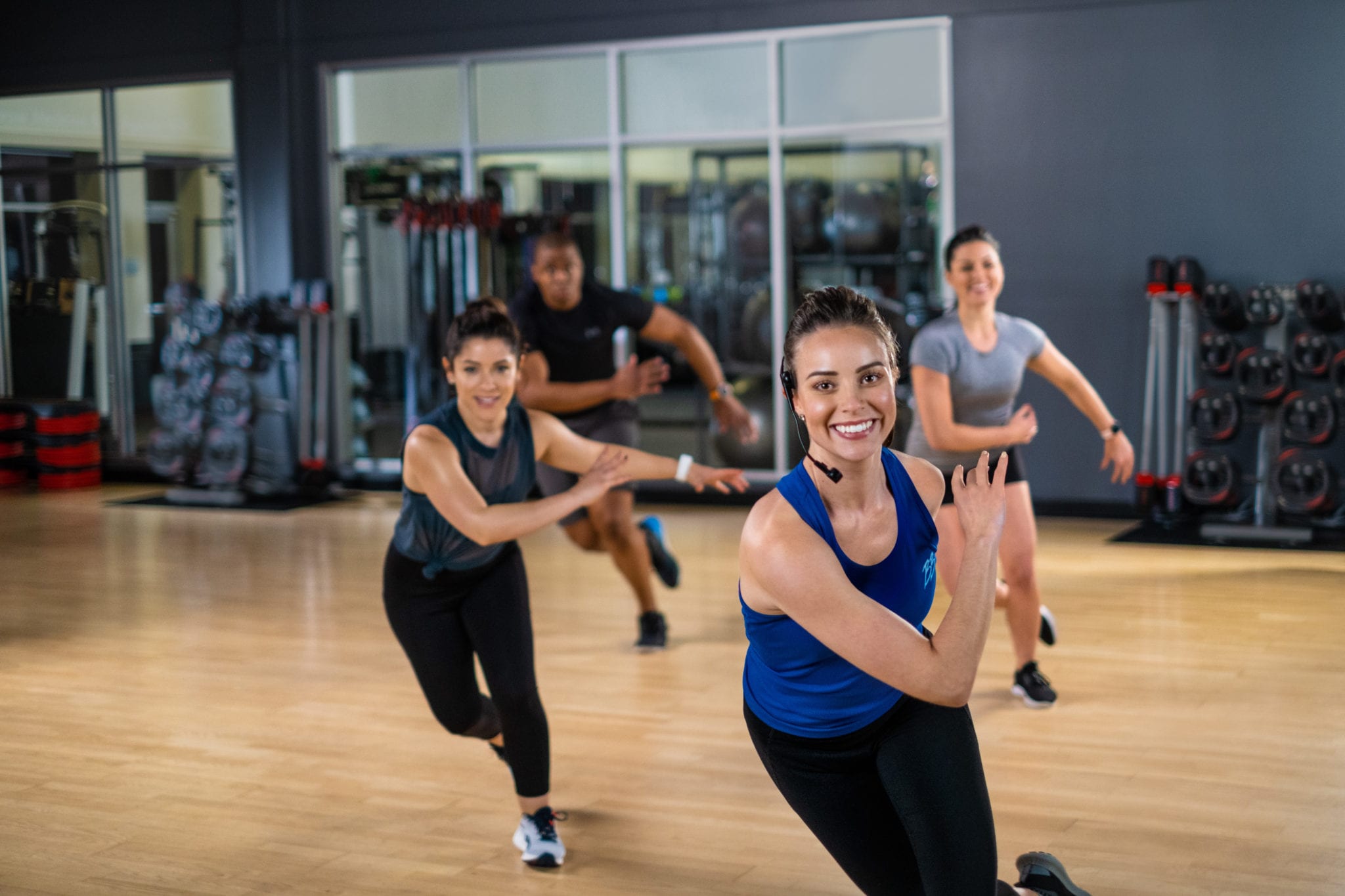 group instructor performing skate movement in fitness class at padonia gym studio