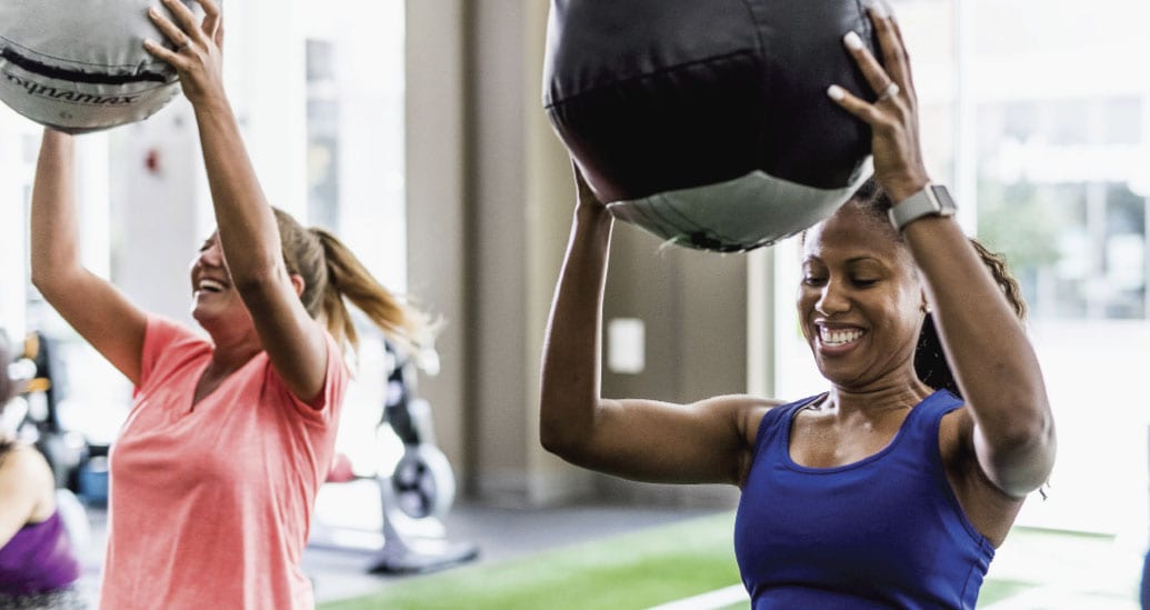 2 women working out with medicine balls