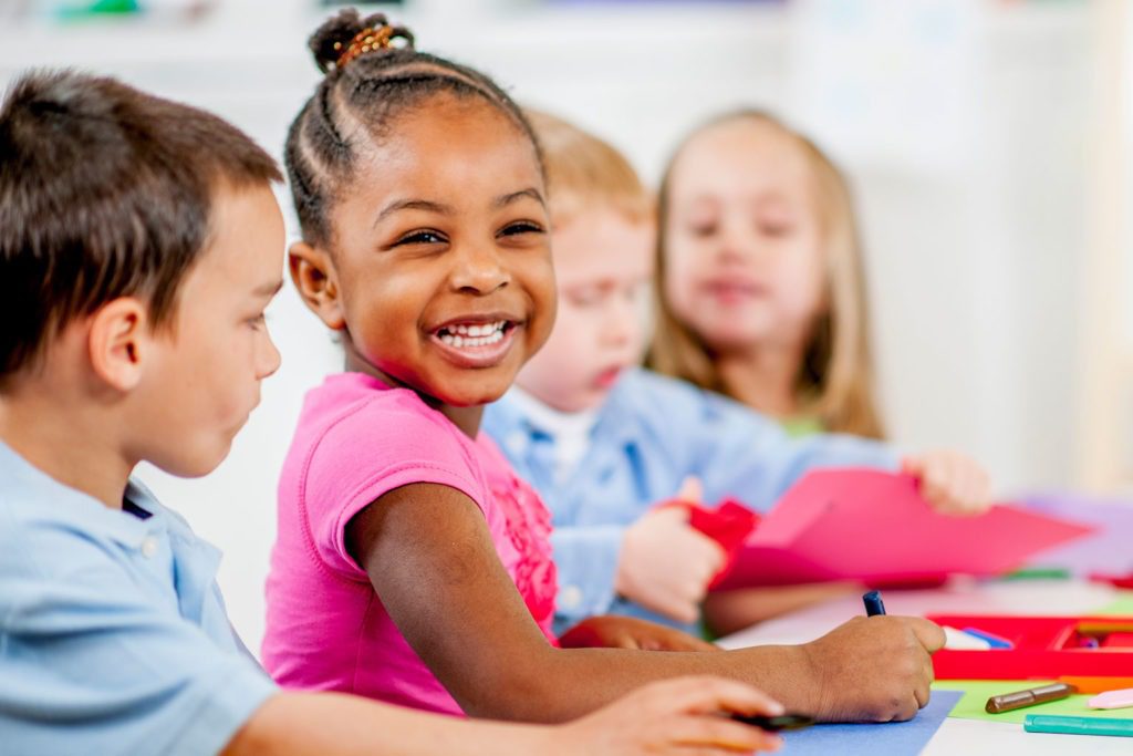 Children laughing and coloring