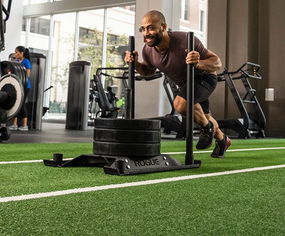 Man pushing sled