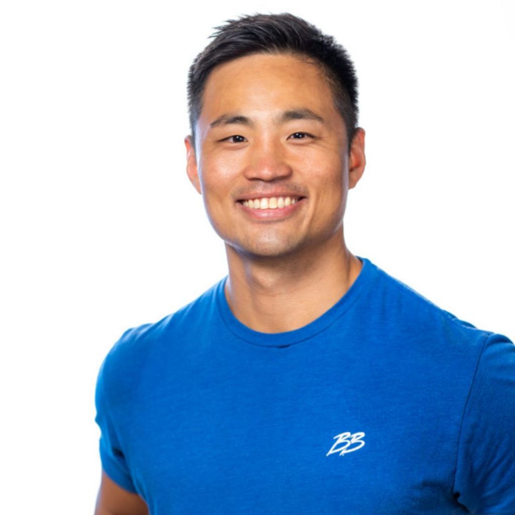 Personal Trainer Andrew Kim wearing a blue shirt and smiling at Brick Bodies Gym Rotunda