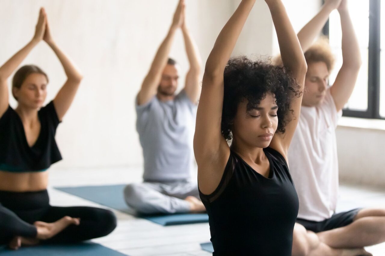 People doing yoga in a yoga studio at Brick Bodies gym