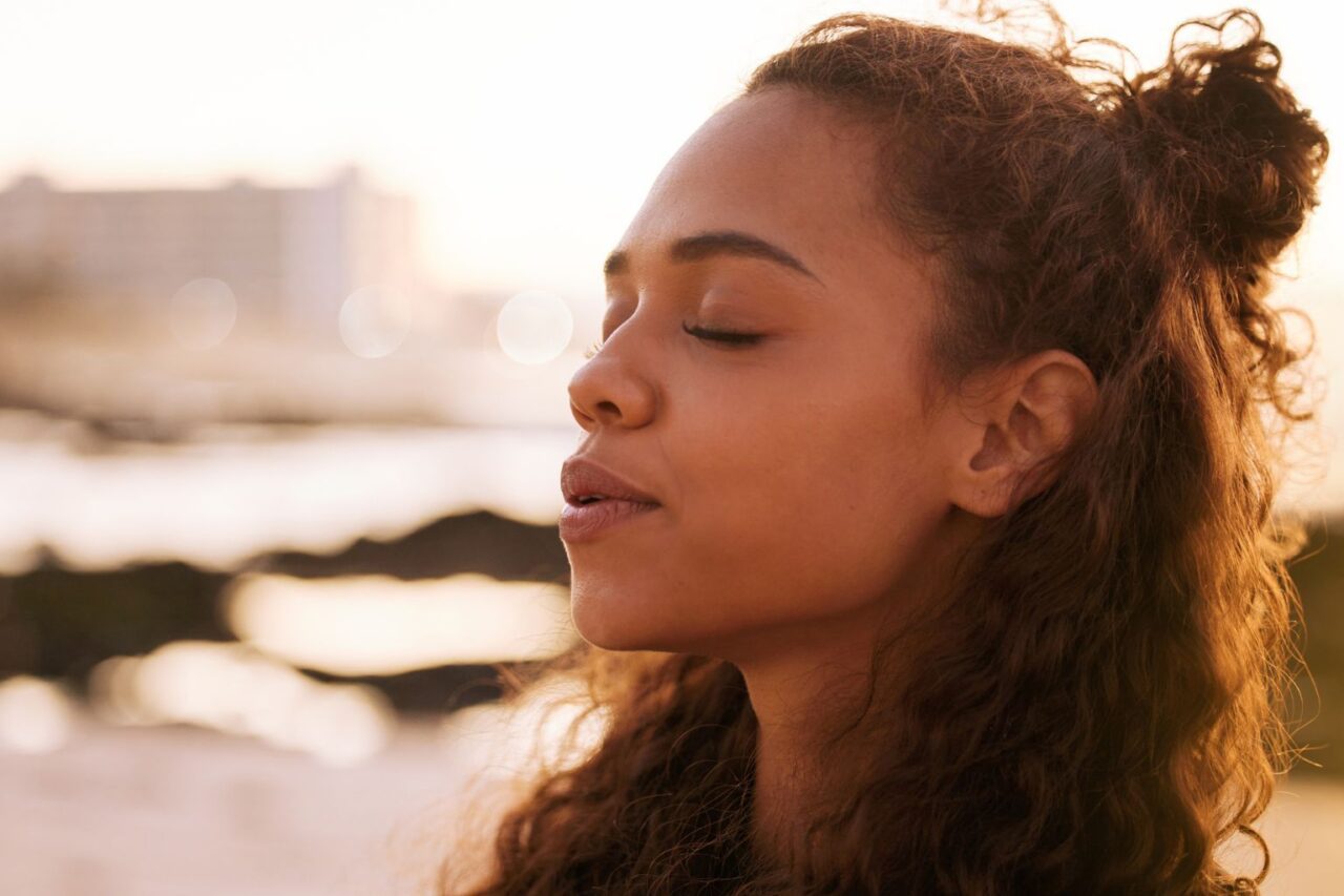 Woman breathing outside and relaxing