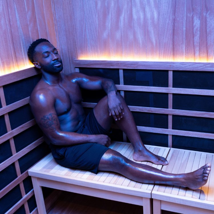 a man sits in an infrared sauna suite at brick bodies padonia