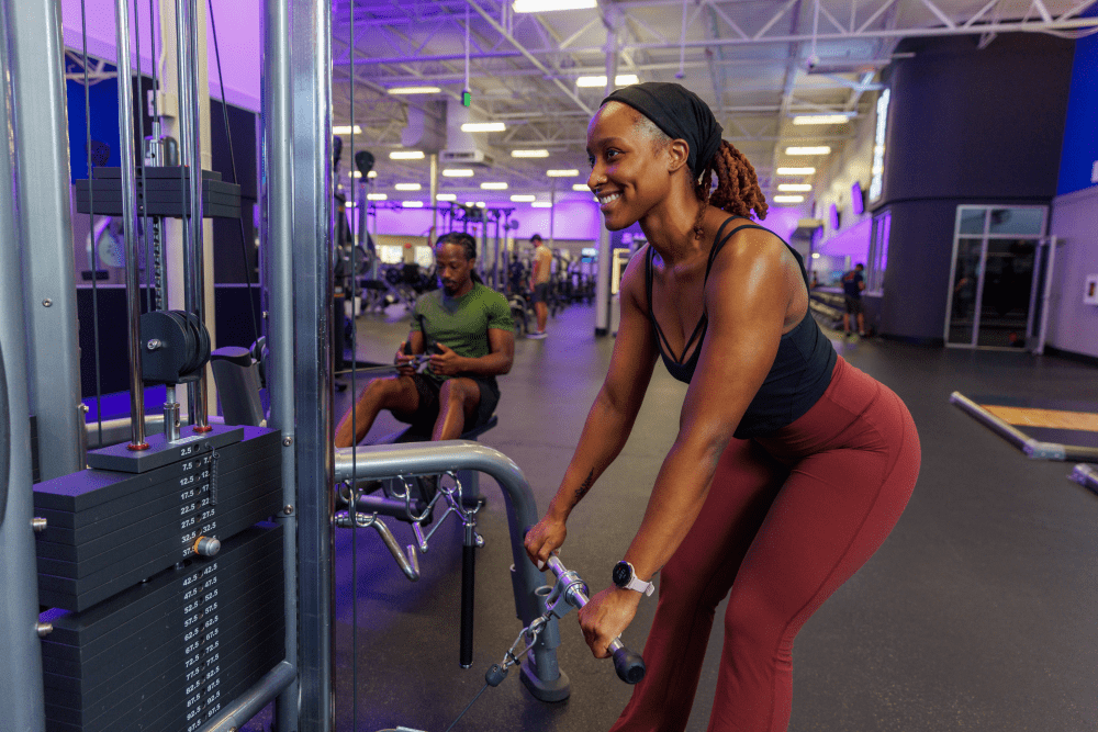 young african american male and female working out on a cable machine